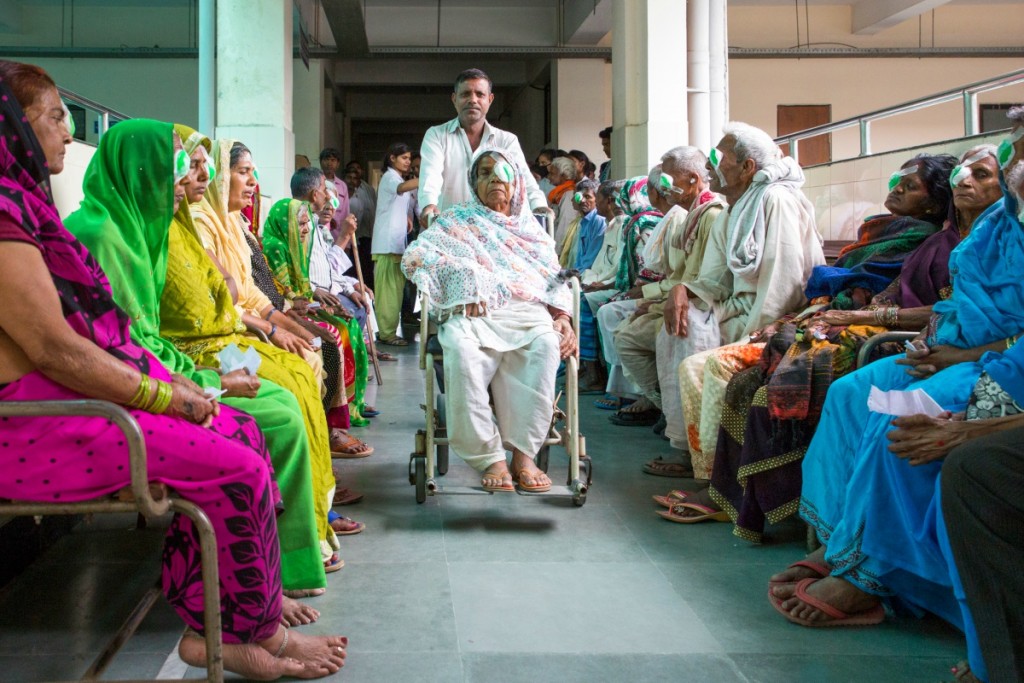 paziente su sedia a rotelle in una sala d'attesa di un ospedale affollato